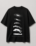 A black short-sleeve crewneck t-shirt with a white graphic print of stacked galaxies and human silhouettes, with the text 'BORN OF STARS, BOUND TO EARTH' printed at the bottom, shown against a neutral gray background.