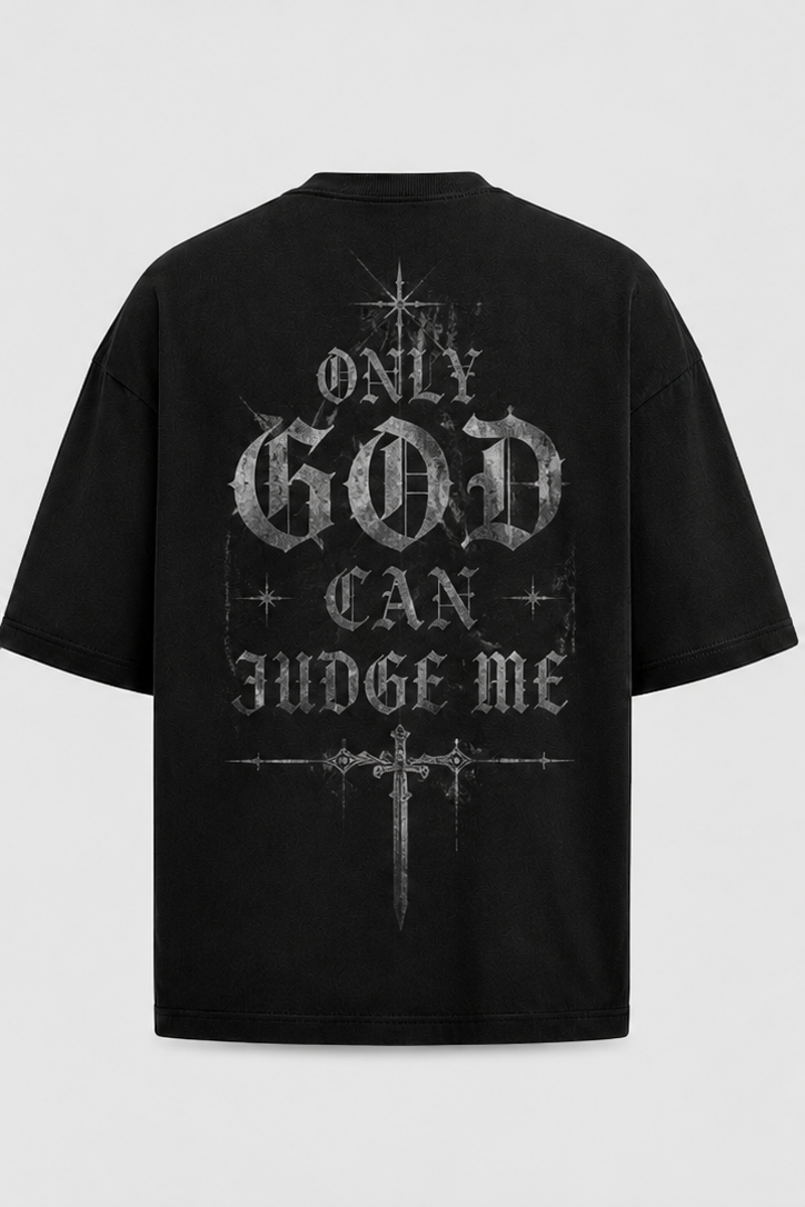 A black short-sleeve t-shirt with a distressed gothic-style graphic on the back reading 'ONLY GOD CAN JUDGE ME' in silver-gray lettering, accompanied by a cross and star details, shown against a light gray background.
